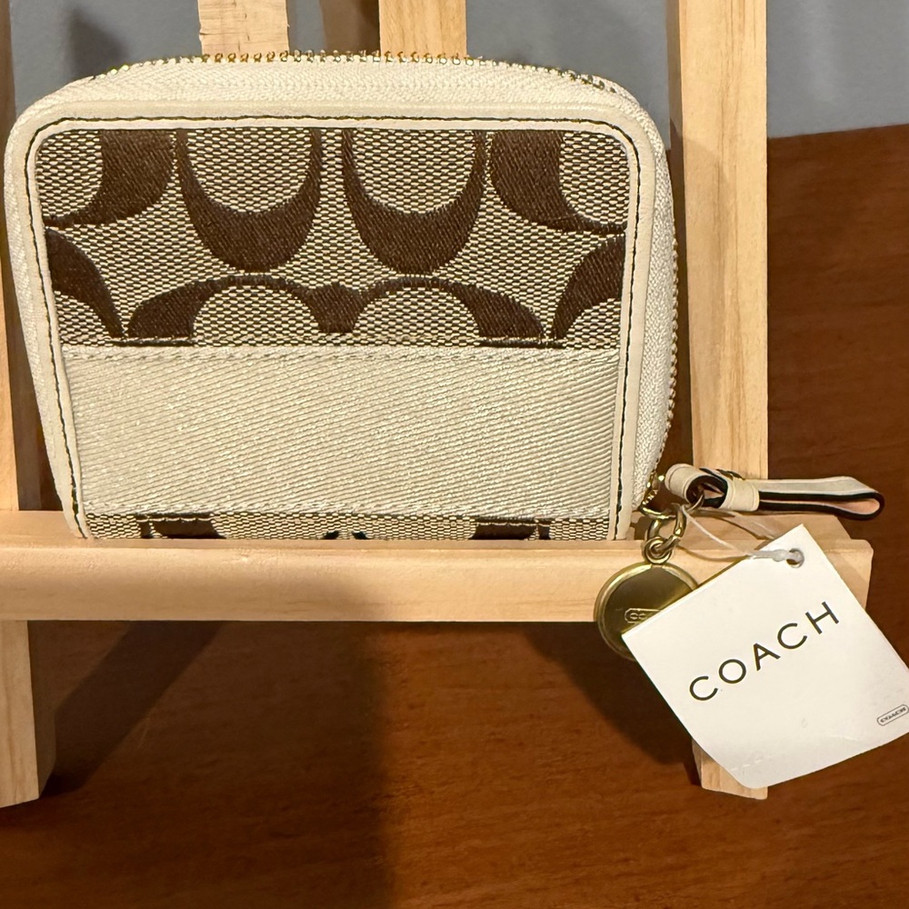Coach Zip Card Case in the signature coated canvas and smooth leather.